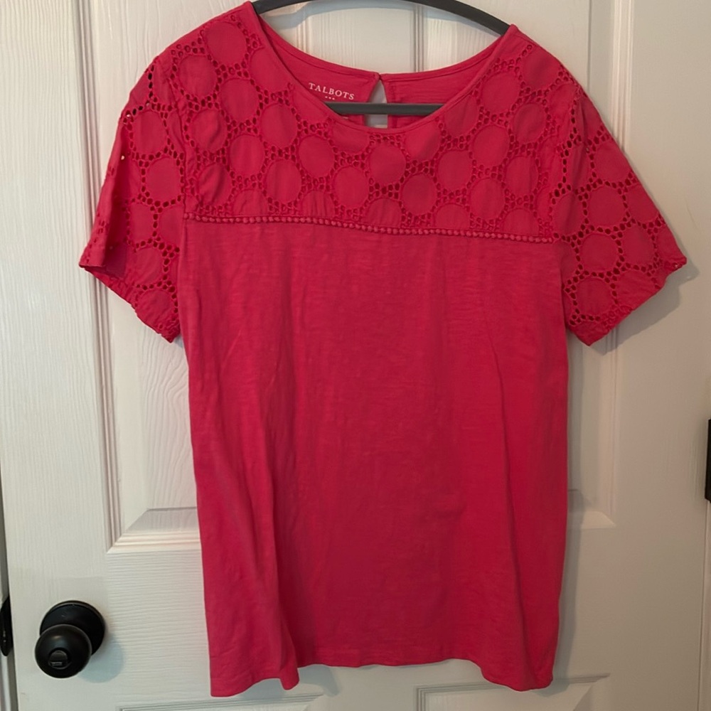 100% cotton. Picture is more red than actual color. More like a light coral.